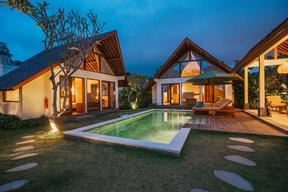 A villa lit up at dusk