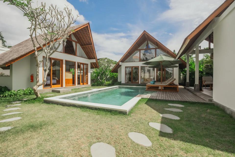 Lawn, pool and pavilion of a villa