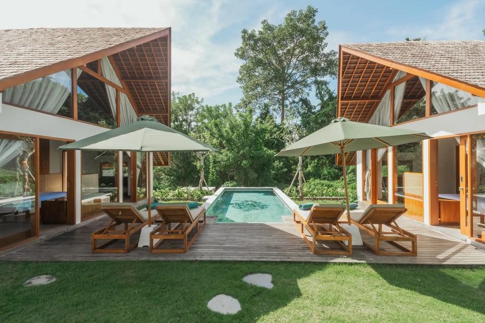 Two villas side by side across a lawn